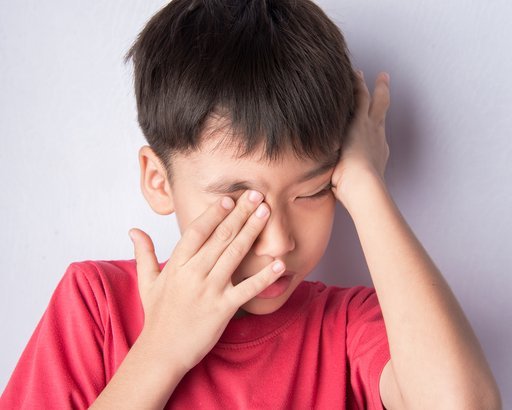 Kid touching mouth, nose and eyes